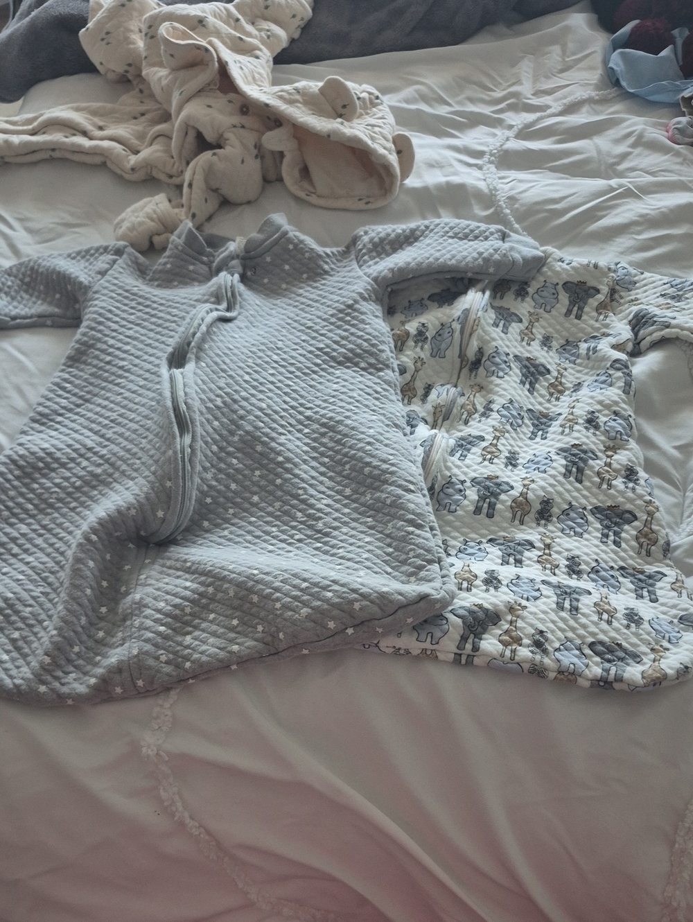 Two Hudson Baby Sleeping, One Gray Quilt And One Animal Print